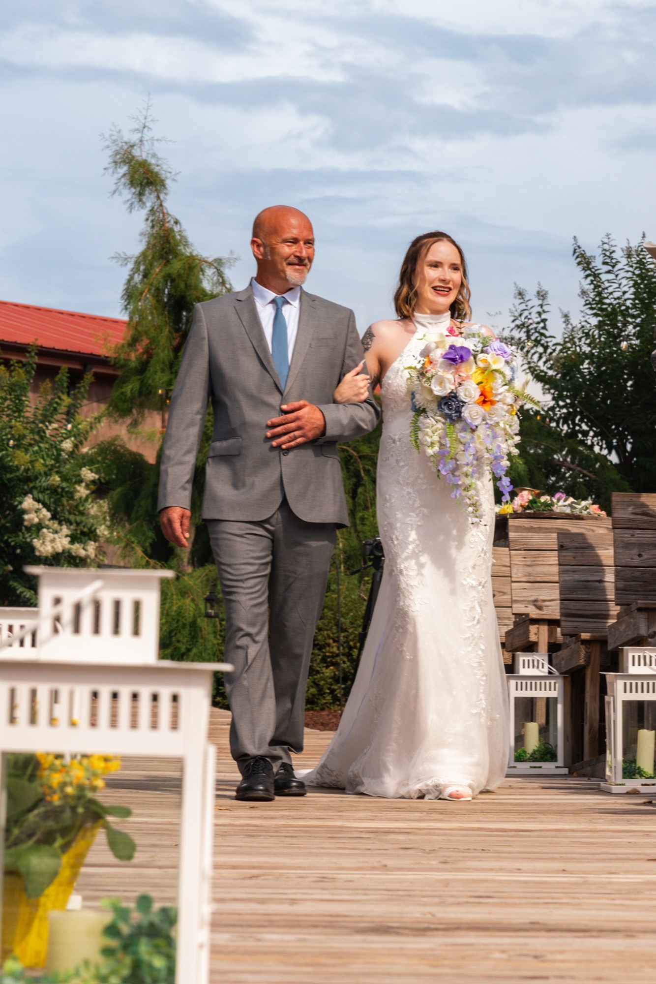 Bride walking down an outdoor aisle with her father