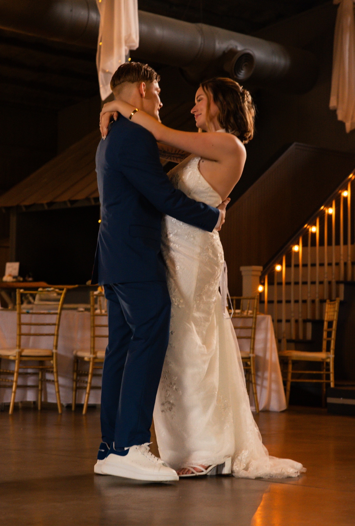 Newlyweds holding each other on the dance floor